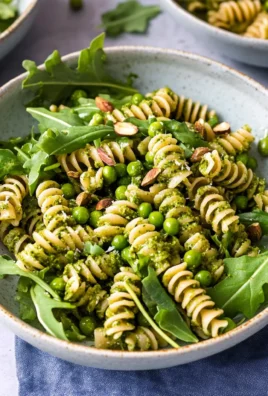 Pesto Pasta with Arugula, Asparagus, Peas, and Pistachios
